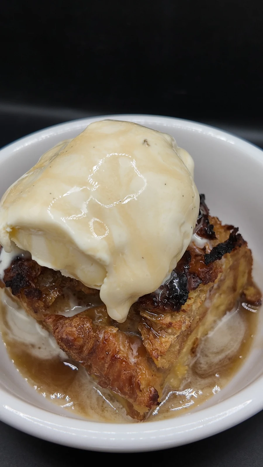 Baked dessert topped with ice cream and sauce