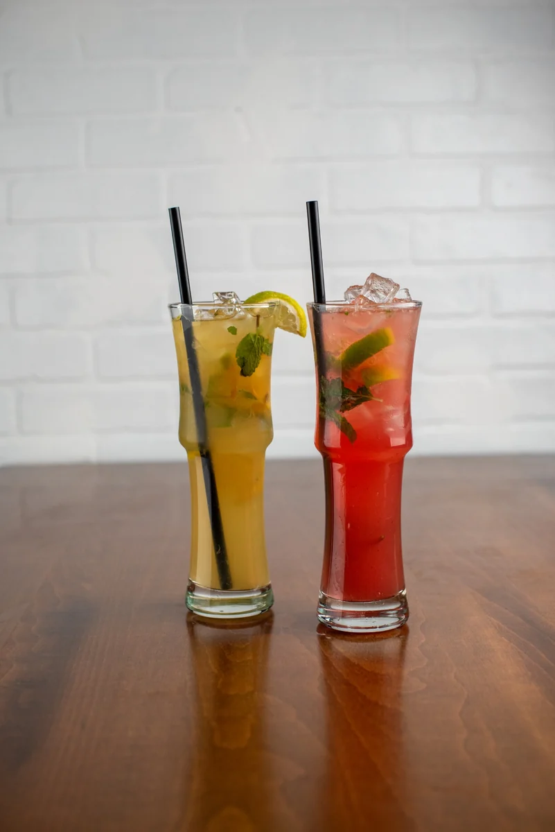 Two bright mojitos with fresh mint and citrus